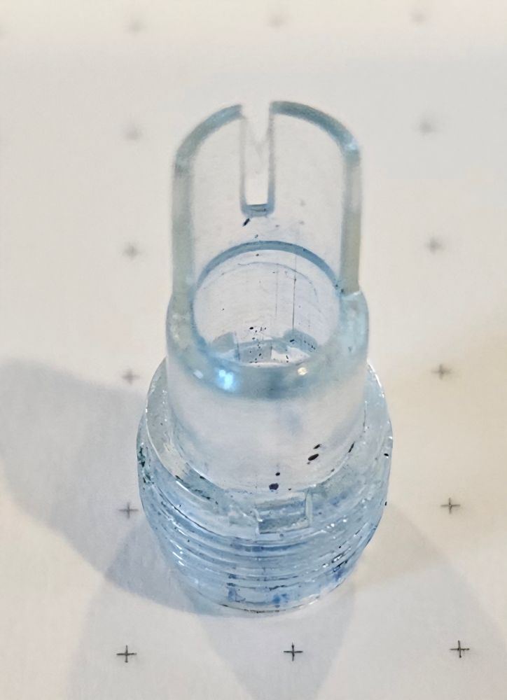 Plastic widget from inside Pilot Scholar. Slot for wrench is just above the threads. 