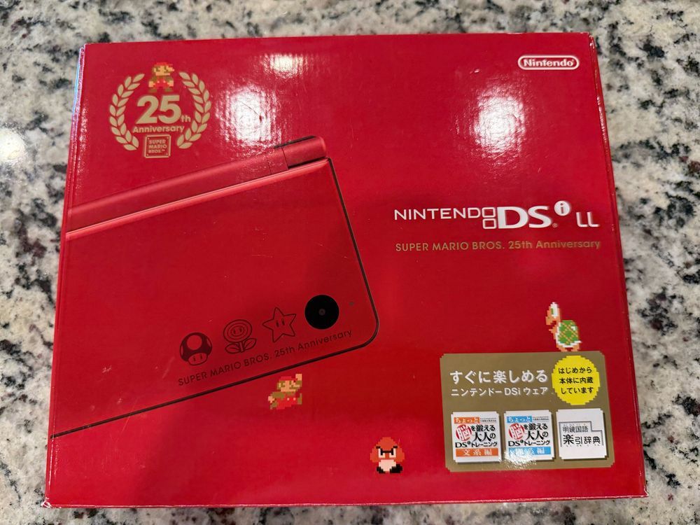 Red Nintendo DSi XL Super Mario Bros. 25th Anniversary edition retail box with Japanese text