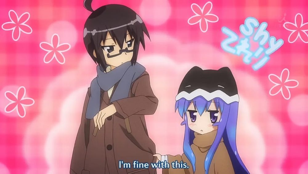 Screenshot of Miniwa Tsumiki and Otonashi Io from "Acchi Kocchi."
Tsumiki is holding the side of Io's jacket with a fluffy pink background and the word "shy" floating above Tsumiki.  It is a very cute scene that gives a vibe of being slightly clingy but shy about it.