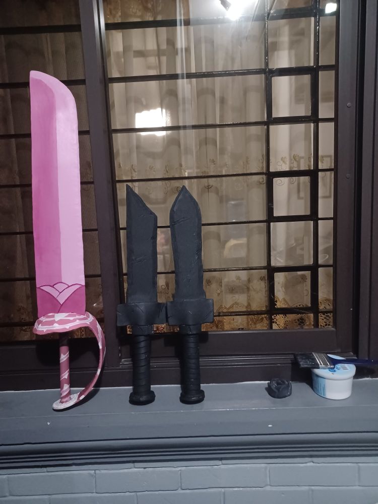 A picture of a pink sword from Steven Universe and two prop daggers that are a WIP
