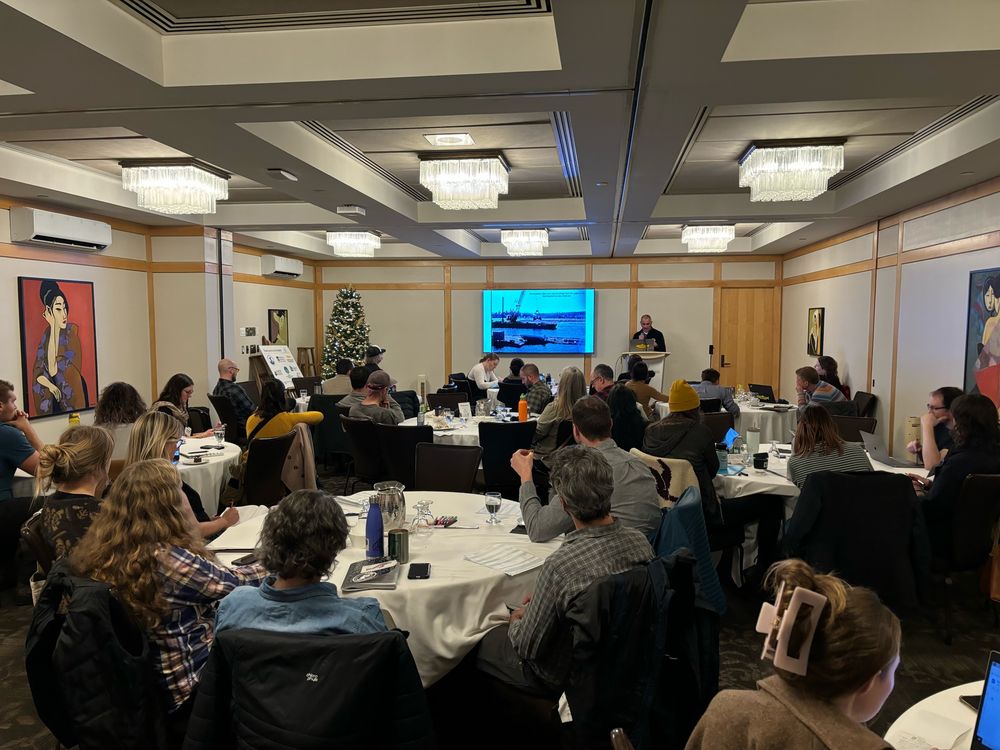 A group of people listening to a presentation on tidal marshes.