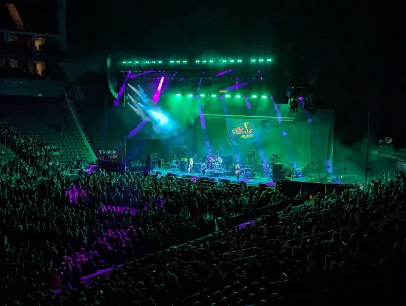Image of a concert in teal/purple lighting