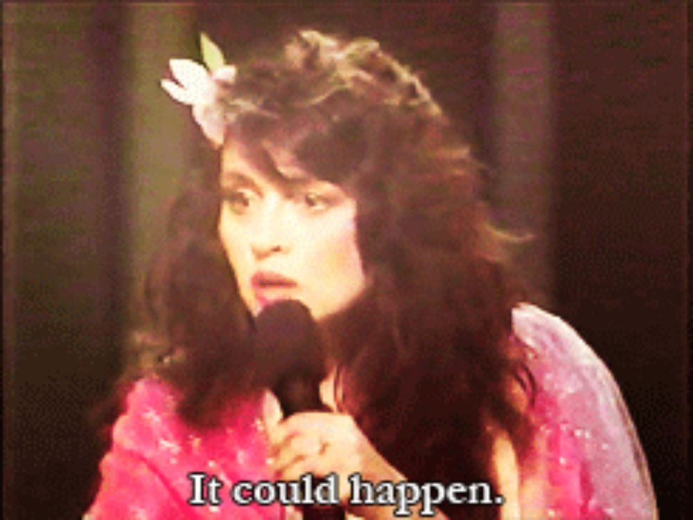 a woman singing into a microphone with the words " it could happen " below her