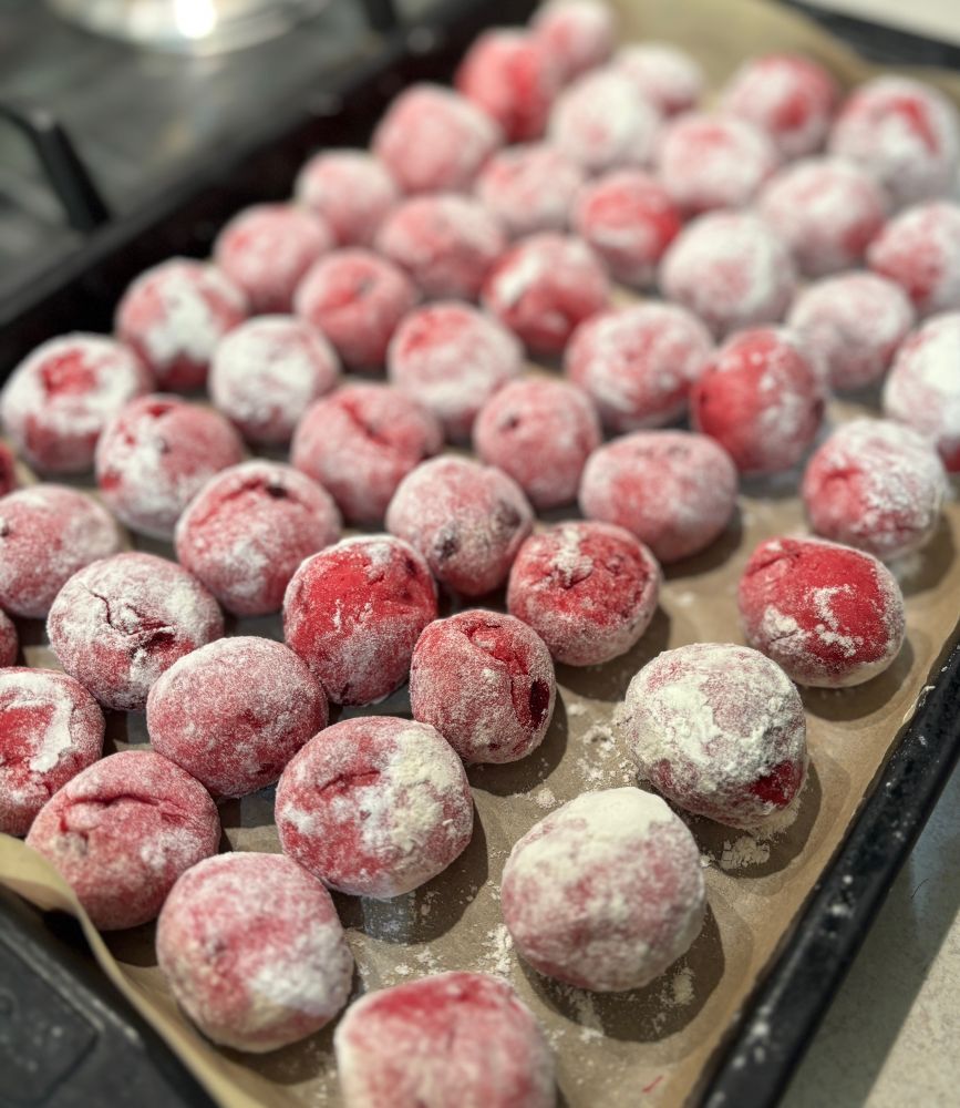 A baking tray covered in beetroot gnocchi