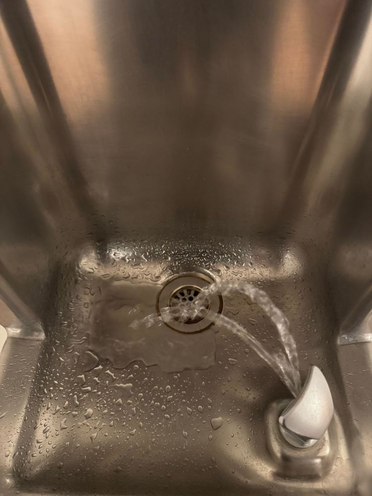 A drinking fountain with two streams of water emitting outwards