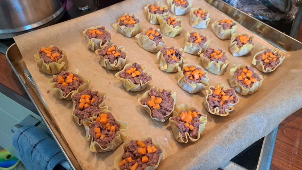 a tray of uncooked siu mai dumplings