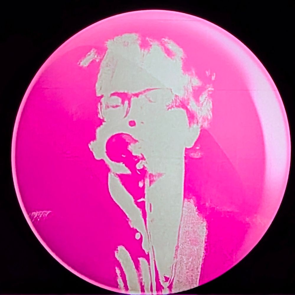 Jarvis Cocker filtered through pink visual effects on the screens at the Glasgow Hydro 