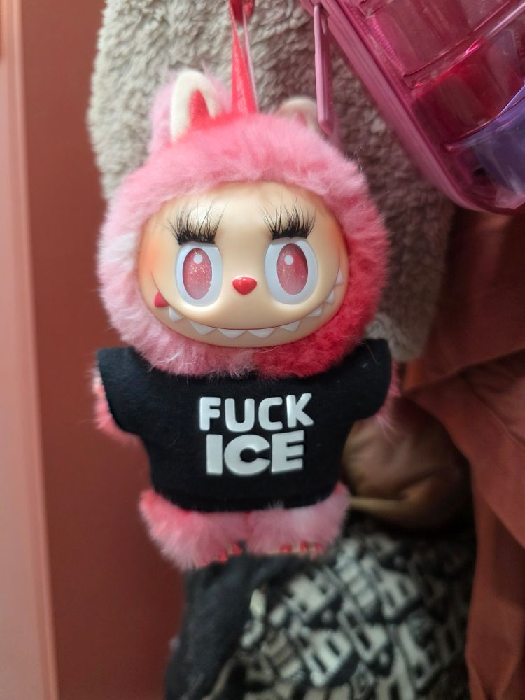 Love Labubu wearing a Fuck ICE shirt and false lashes 