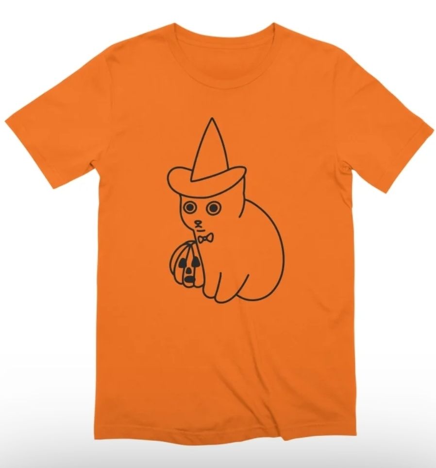 Orange T-shirt with line drawing of a kitten sitting next to a jack-o'-lantern. The kitten is wearing a witch's hat and a cute little bowtie.