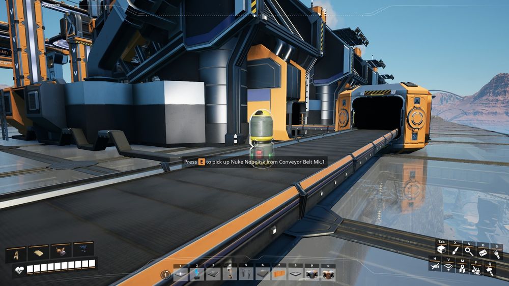 Screenshot of Satisfactory. Watching Nuke Nobelisk be manufactured from the final machines and carried on a conveyor towards storage.