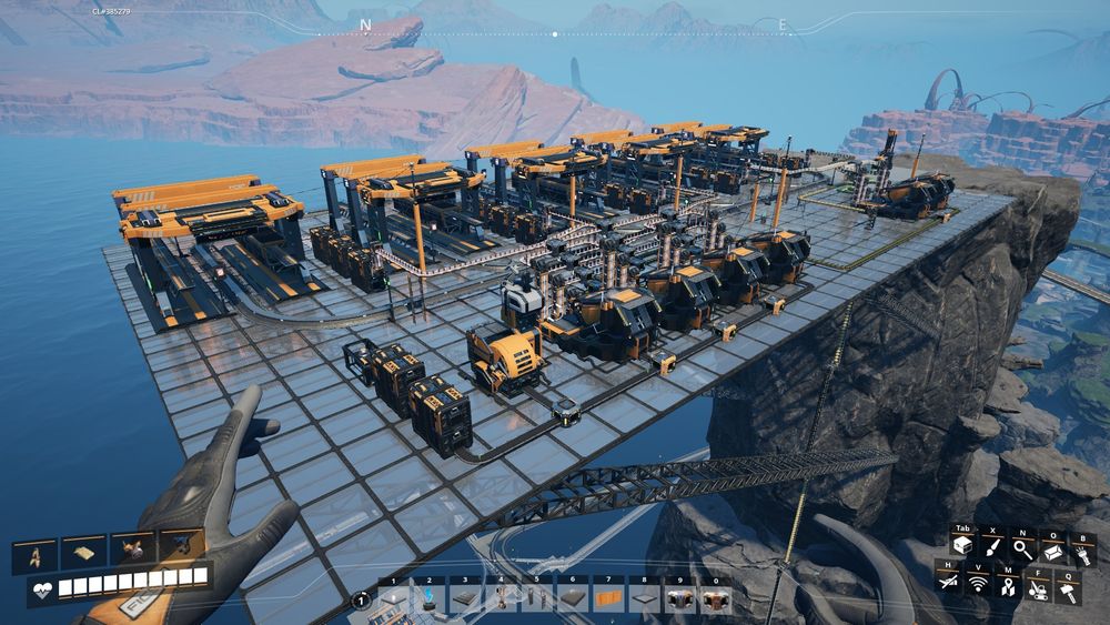 Screenshot from Satisfactory. A train hub and manufacturers for making Nuke Nobelisk using the nearby Uranium node.
