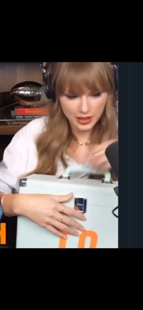 Taylor swift holding a vinyl case 