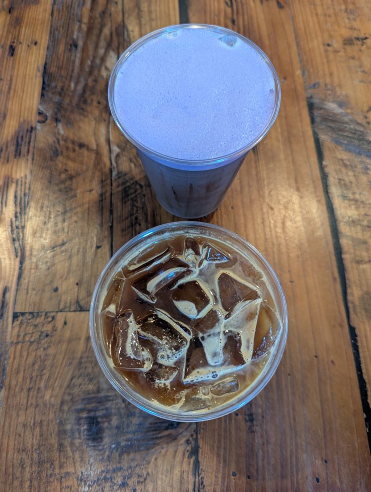 An Ube coldfoam coffee and a Thai tea on a wooden table