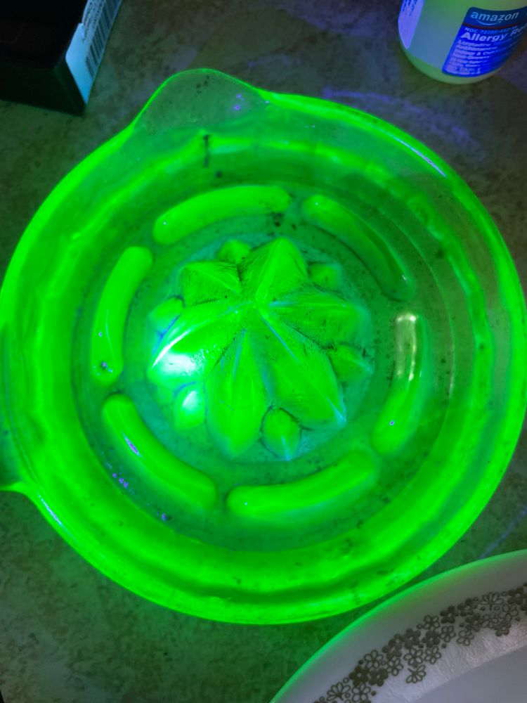 Sick as hell uranium glass juicer that is lit up neon green under a strong UV light 