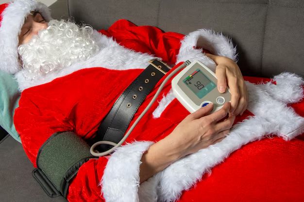 Santa Claus, maybe the same one, laid up on a slightly different couch, this time taking his own blood pressure (quiche related????) with a big cuff and some sort of digital readout. Is "90" good
