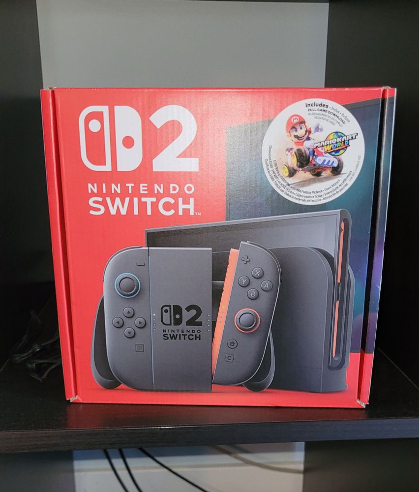 The Nintendo Switch 2 in my possession, the Switch 1 cowering behind it.