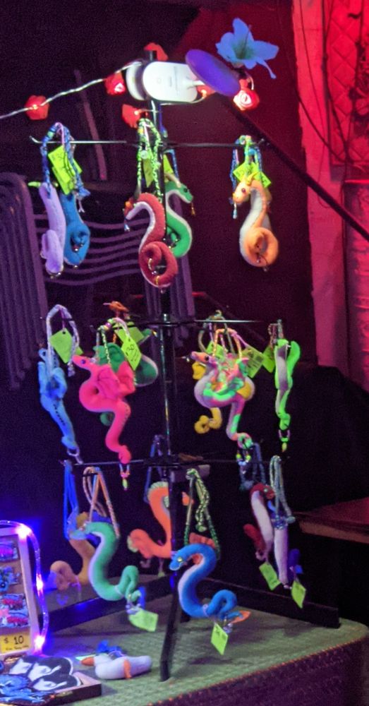 a photo of the plushie ornaments that got stolen. there's several kinds of dragons and that lil goose at the bottom