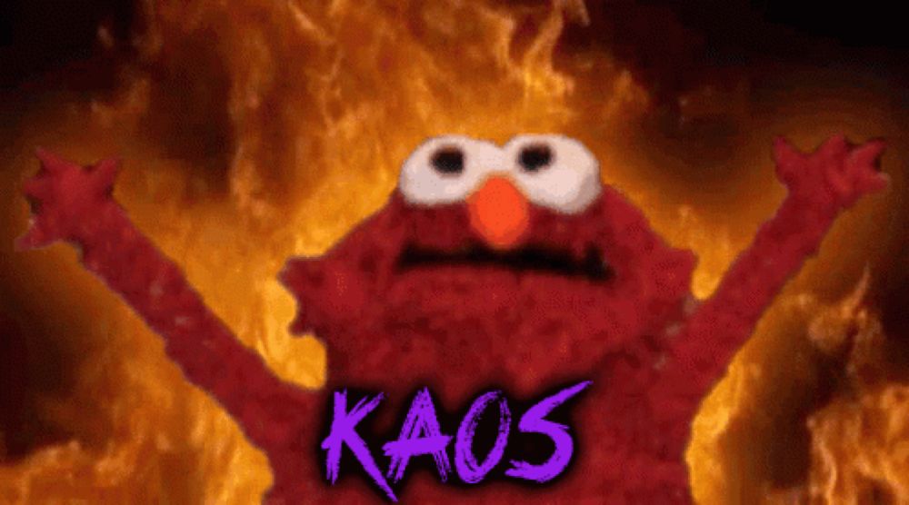 elmo from sesame street stands in front of a fire with kaos written in purple letters