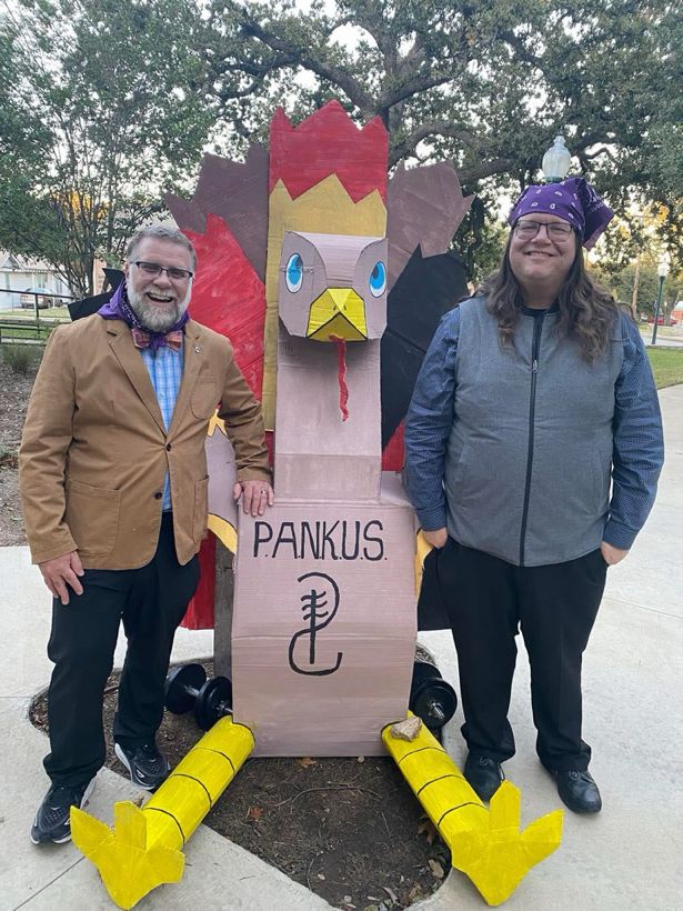 Jim, a (unnamed) large turkey decoration with the PANKUS logo, and Karl. Jim and Karl are wearing purple bandanas from the PANKUS students’ fundraiser