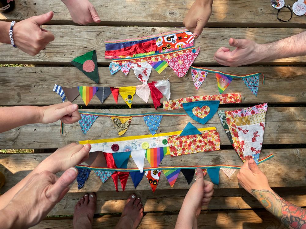 An overhead shot of handmade bunting with hands giving thumbs up.