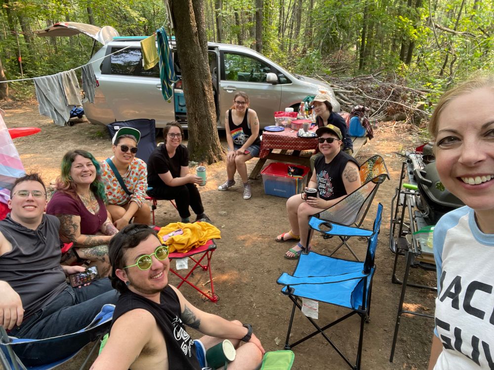 Nine pirates sitting 🪑 n camp chairs on the kitchen campsite.