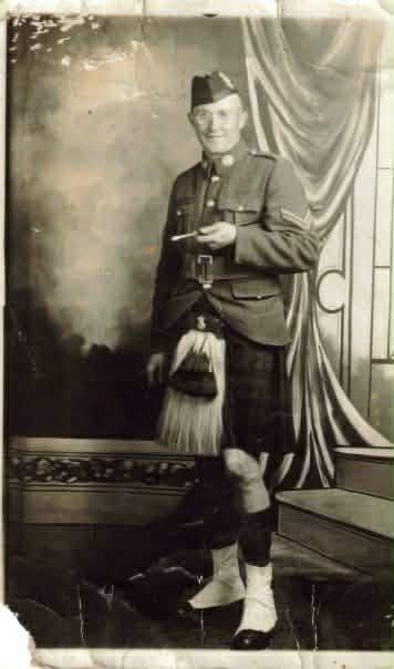 A soldier in the dress uniform of the North Nova Highlanders. He is wearing a kilt and wears little round glasses. The photo is from circa 1939.
