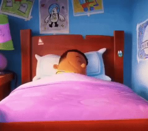 a cartoon character is sleeping in a bed with a pink blanket .