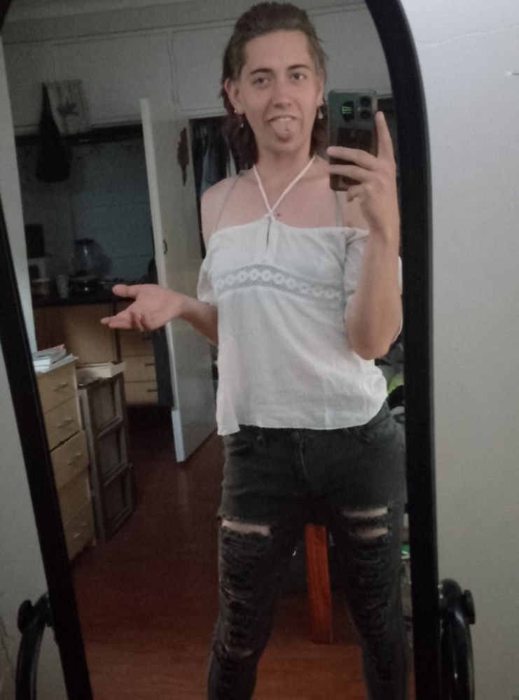 Me I. A white off the shoulder top and black ripped jeans