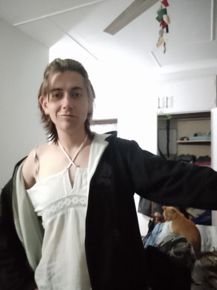 Me in a white off the shoulder top and my bf's hoodie. Our cat Tom is under my arm