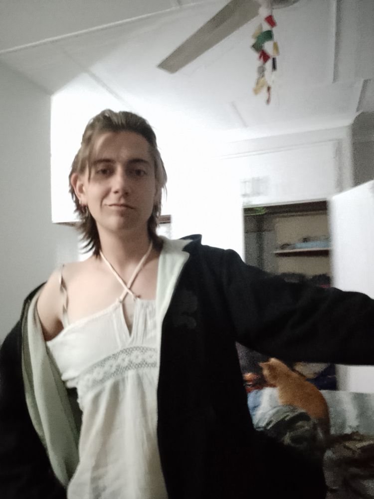 Me wearing a cute off the shoulder white top and my boyfriend's hoodie. Our ginger cat Tom is in the background