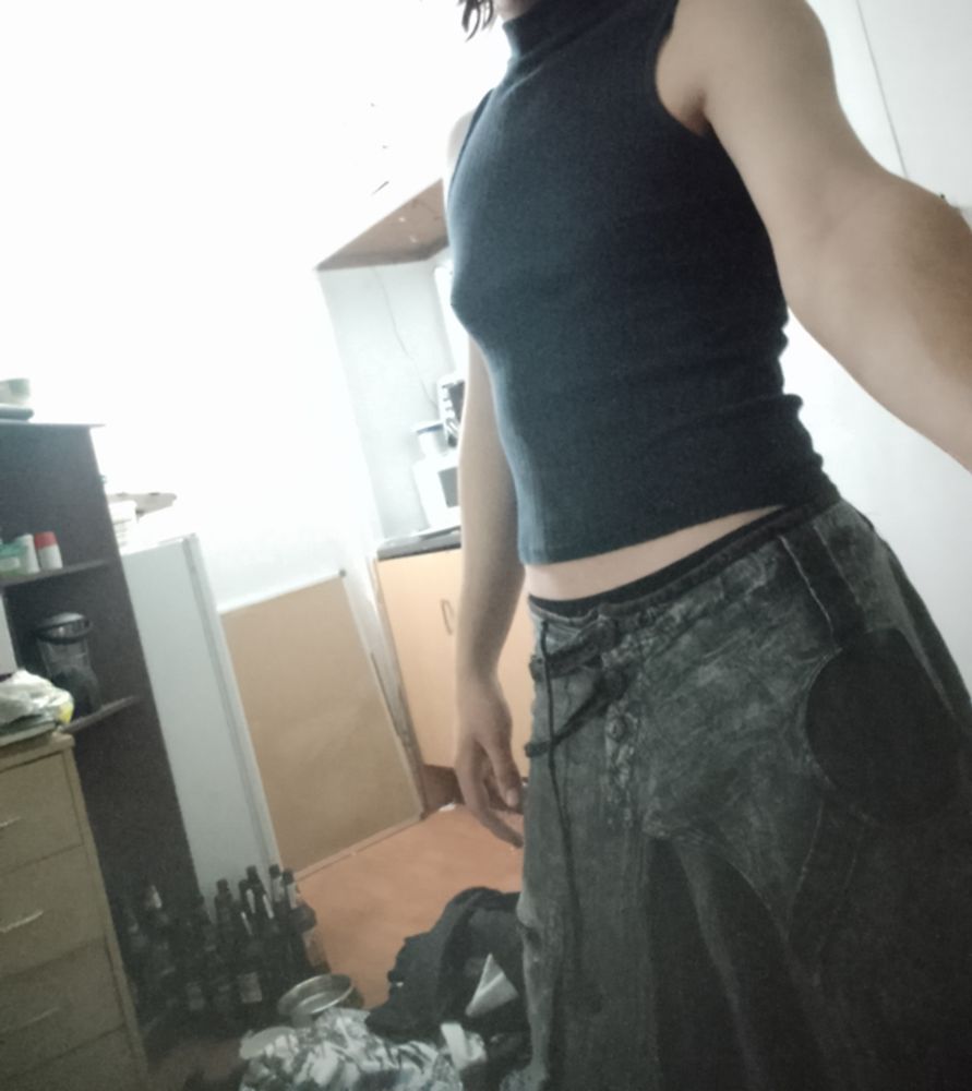 Me in a turtle neck vest and boho pants