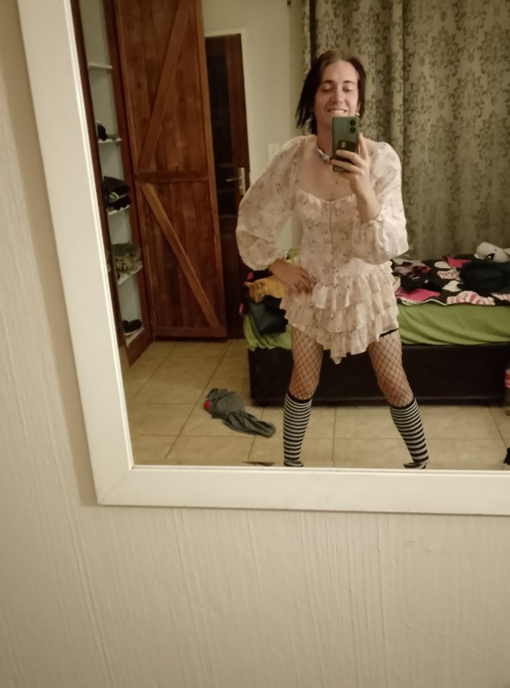 Me in a cute frilly skirt, fishnets, thigh highs and a stitch collar.