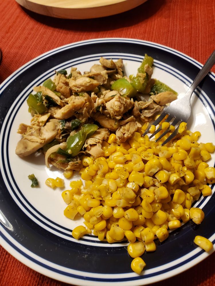 A plate of stir fry and corn