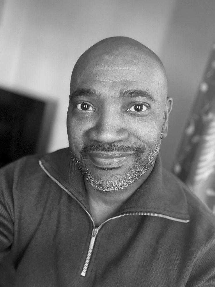 Black & White medium shot of me wearing a 3/4 zip sweater