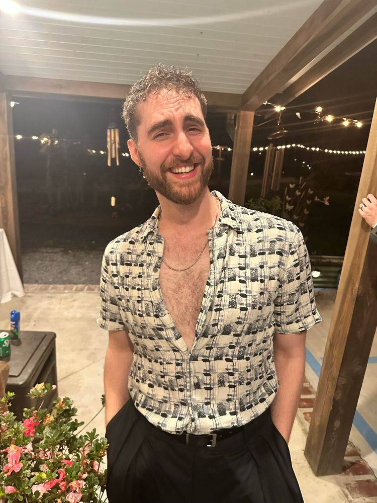 Myself in a button down dress shirt with my chest exposed.