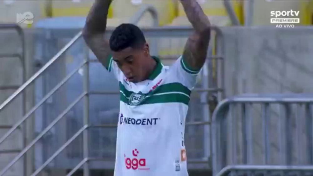 a soccer player in a green and white jersey with neodent on the front