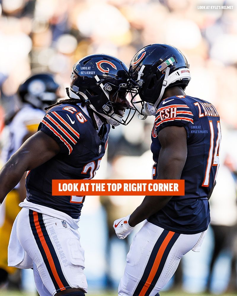 Two Chicago Bears players celebrate on the field, standing helmet-to-helmet. The player on the left wears jersey number 25, and the player on the right wears jersey number 14. Both are in navy blue Bears uniforms with orange and white accents. White text has been edited onto the image, labeling different parts such as “LOOK AT OZ’S JERSEY,” “LOOK AT KYLE’S HELMET,” and “LOOK AT KYLE’S PANTS.” A bold orange bar across the center reads “LOOK AT THE TOP RIGHT CORNER.” The background shows a blurred stadium crowd. Ultimately it leads the reader to a reminder of the Bears current 8-3 record. 