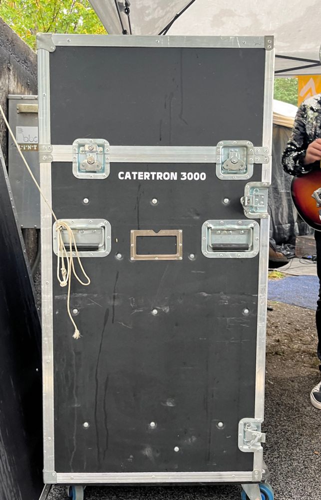 it is a box on wheels with handles that says CATERTRON 3000 on the side, i think it has sound gear in it