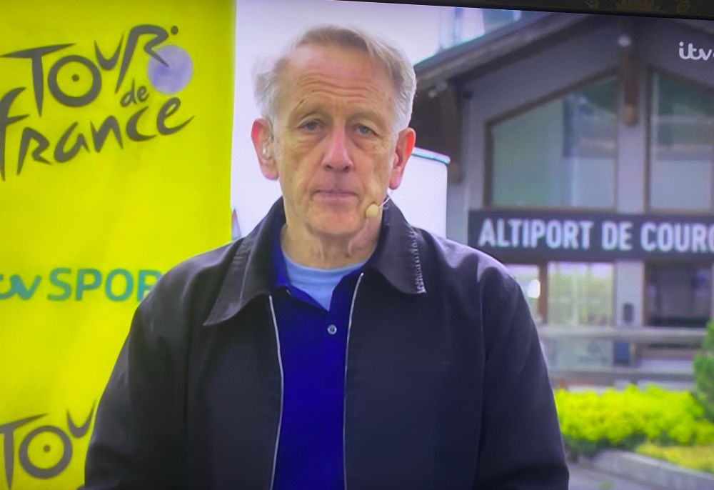 Presenter of ITV’s Tour de France coverage looking downbeat in a coat