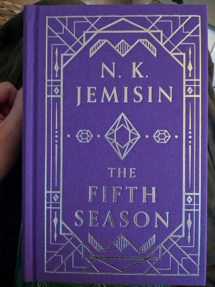 The purple and silver cloth bound cover of N.K. Jemisin's novel "The Fifth Season"