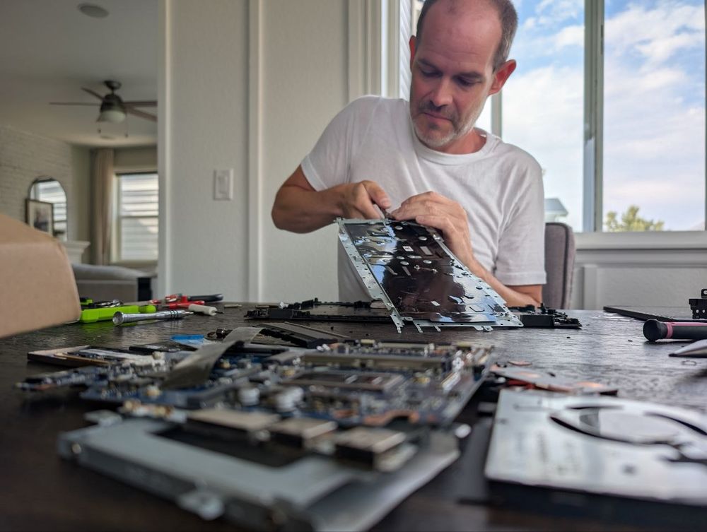 Me, removing a laptop keyboard from the retention bracket. There were about 40 plastic welded fasteners, which are the stupidest things ever