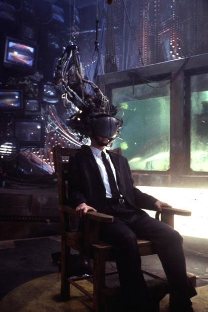 Screenshot from the movue Johnny Mnemonic.
Johnny (Keanu Reeves, in suit, strapped into a chair, his head half covered with complex wires & electronics Attached to a supercomputer) is having data extracted directly from his brain (or at least they are trying to).


[Every day, like this on socials and the apps]