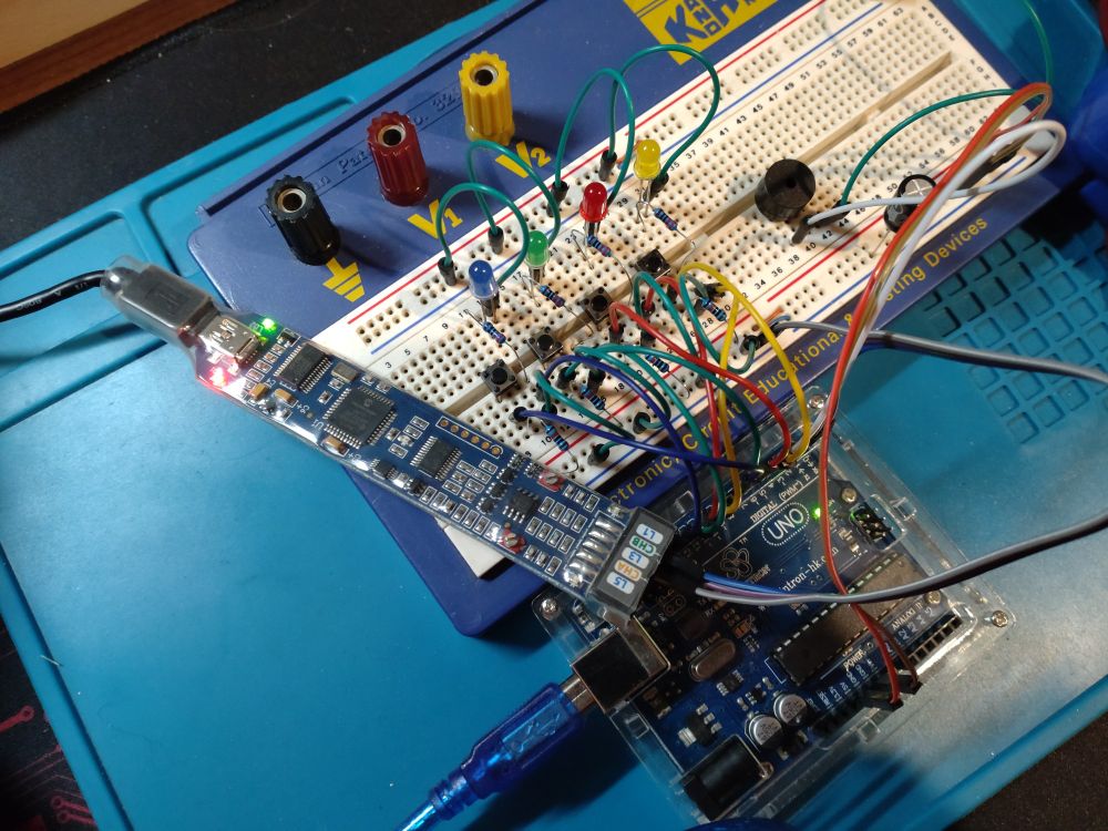 Arduino connected to some buttons and LEDs on a solderless breadboard with a BitScope BS05 connected to monitor the serial lines 
