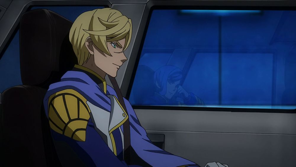 McGillis sitting inside a car, through the window you can also see Gaelio, they're both smiling 