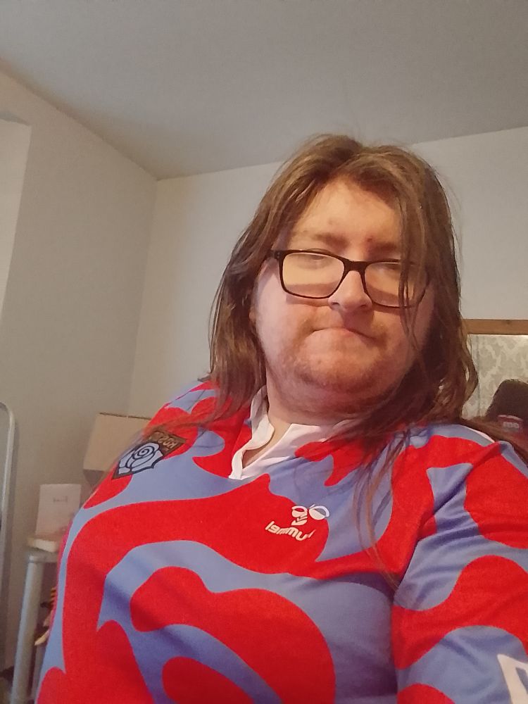 Me a (Trans Woman not on hormones) wearing my boobs with a Les Roses de Montreal shirt on. 