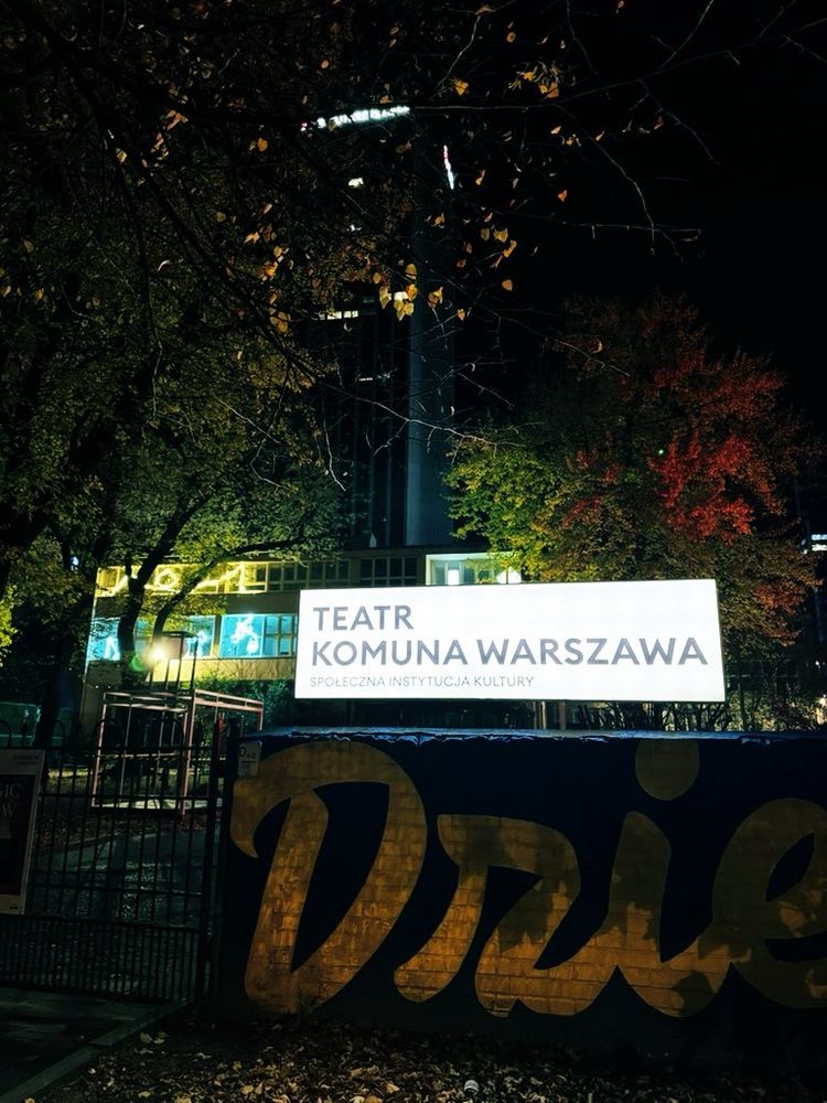 Backlit sign at the entrance of Teatr Komuna Warszawa, an arts venue and theatre in Warsaw