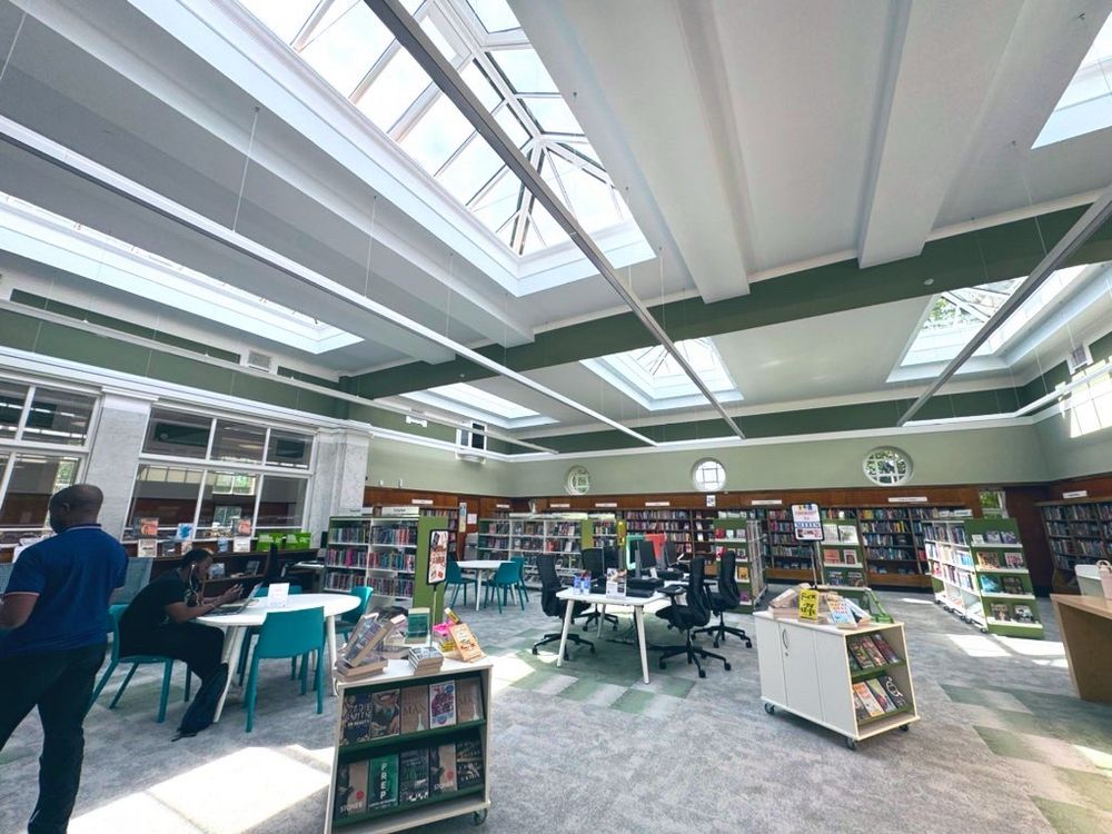 Inside the newly renovated Elder Park library. Lots of books on display with light coming through a glass ceiling