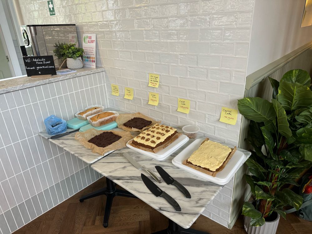 Lots of vegan bakery on a table beside a plant