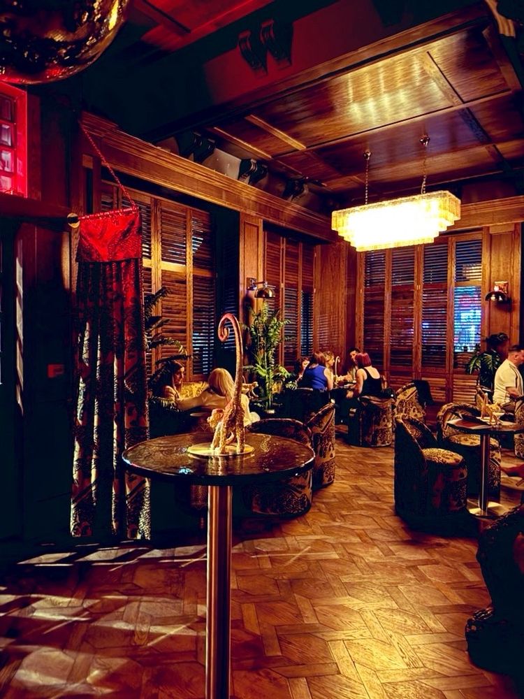 a wood panelled lounge room. a brads monkey is bearing its bum