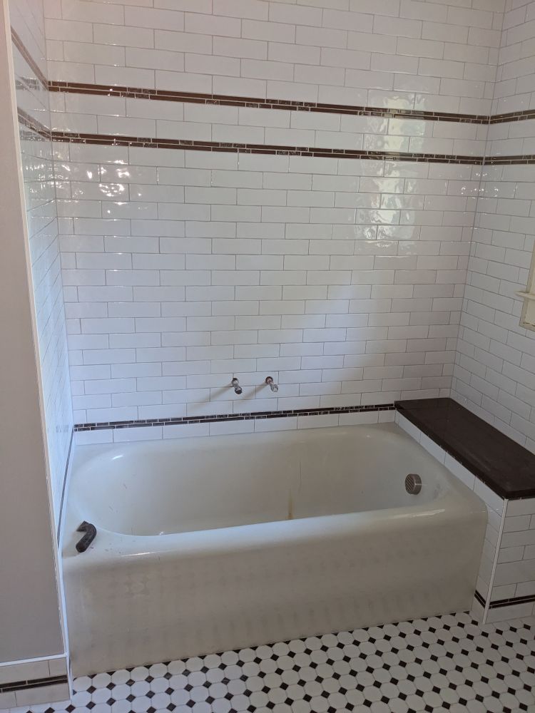 Bathtub and shower area of bathroom.